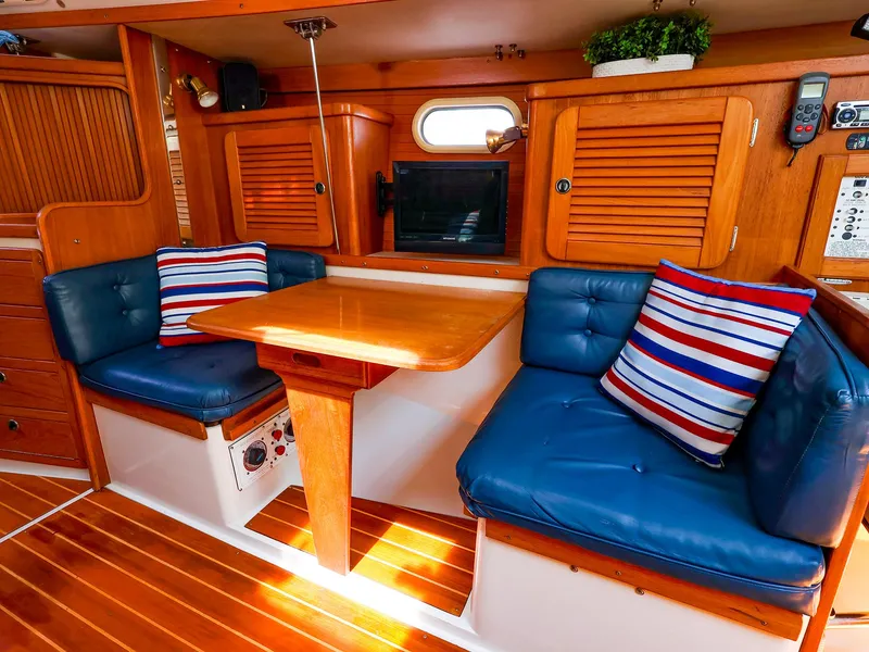 Slide: The Image of Interior of 2001 Catalina 36 MkII sailboat with blue cushions and striped pillows. - 22