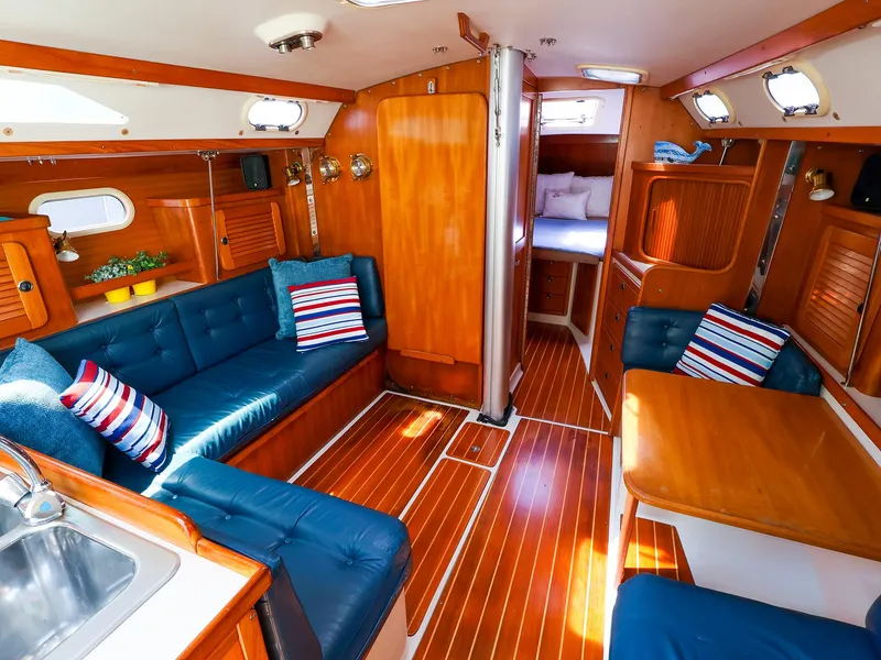 Slide: The Image of Interior of 2001 Catalina 36 MkII sailboat with wooden finish and blue seating. - 23