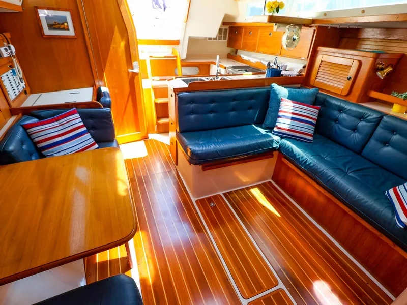Slide: The Image of Interior of a 2001 Catalina 36 MkII sailboat with blue seating and wooden finishes. - 24