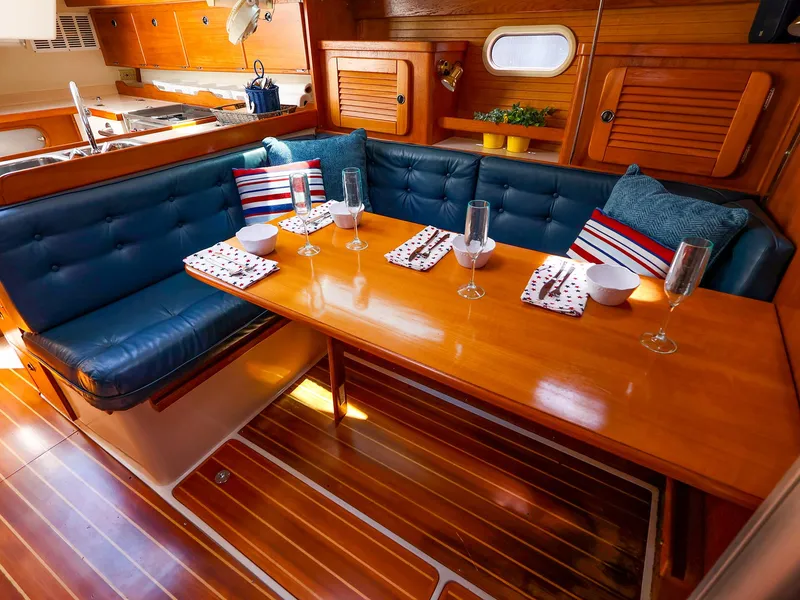 Slide: The Image of Interior of 2001 Catalina 36 MkII sailboat with cozy dining area and wooden finishes. - 36
