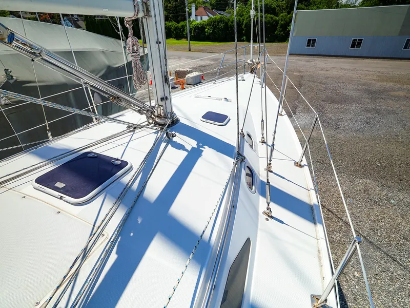 Slide: The Image of 2001 Catalina 36 MkII sailboat deck with rigging and hatches, docked outdoors. - 4