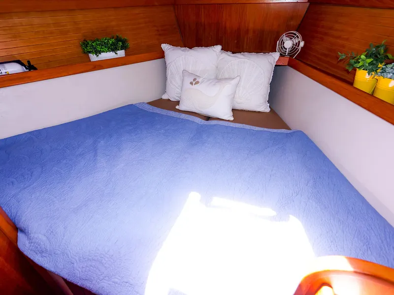 Slide: The Image of Cozy cabin bed in 2001 Catalina 36 MkII sailboat with blue quilt and decorative pillows. - 41
