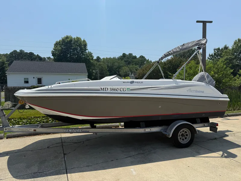 The Image of 2013 Hurricane SunDeck Sport 188 OB boat on trailer, parked outdoors. - 0