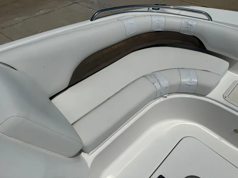 Slide: The Image of 2013 Hurricane SunDeck Sport 188 OB boat interior with white cushioned seating. - 12