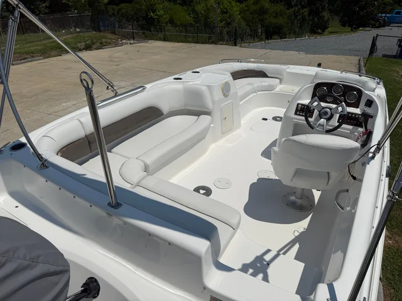 Slide: The Image of 2013 Hurricane SunDeck Sport 188 OB boat interior with white seating and steering console. - 5