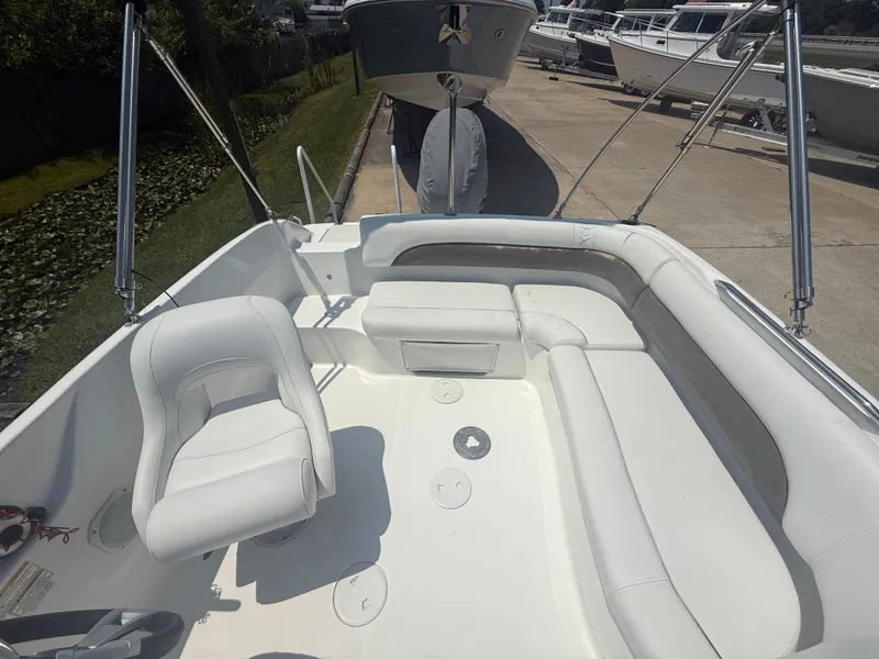 Slide: The Image of 2013 Hurricane SunDeck Sport 188 OB boat interior with white seating and helm chair. - 6