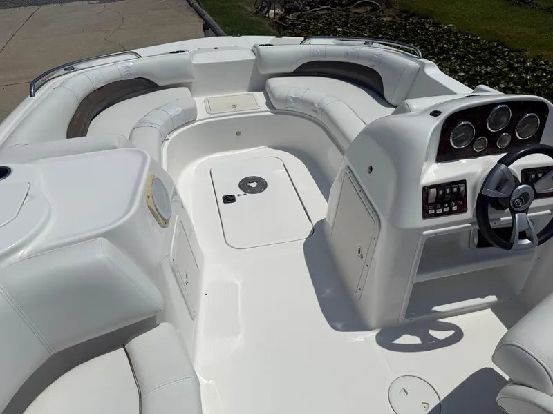Slide: The Image of 2013 Hurricane SunDeck Sport 188 OB boat interior with white seating and control panel. - 9