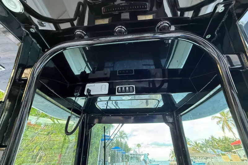 Slide: The Image of Interior view of 2015 Hydra-Sports 3400 CC boat with electronic controls and tropical background. - 59
