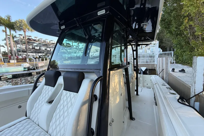 Slide: The Image of 2015 Hydra-Sports 3400 CC boat with luxurious seating at a marina dock. - 60