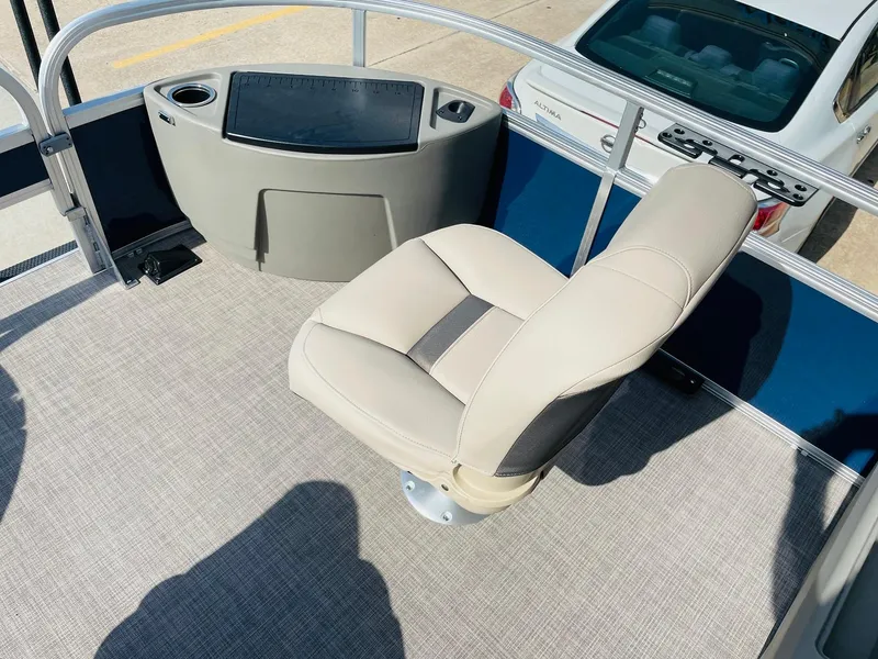 Slide: The Image of 2025 Sun Tracker Bass Buggy 18 DLX boat interior with captain's chair and console. - 11