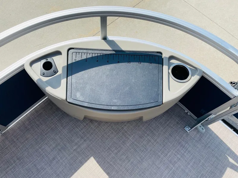 Slide: The Image of 2025 Sun Tracker Bass Buggy 18 DLX boat deck with cup holders and measuring board. - 13