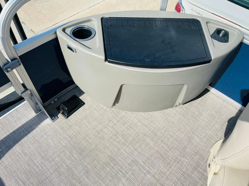 Slide: The Image of 2025 Sun Tracker Bass Buggy 18 DLX boat interior with cup holder and storage. - 15