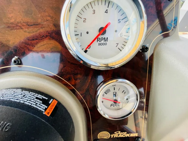 Slide: The Image of Sun Tracker Bass Buggy 18 DLX 2025 dashboard with RPM and fuel gauges. - 20