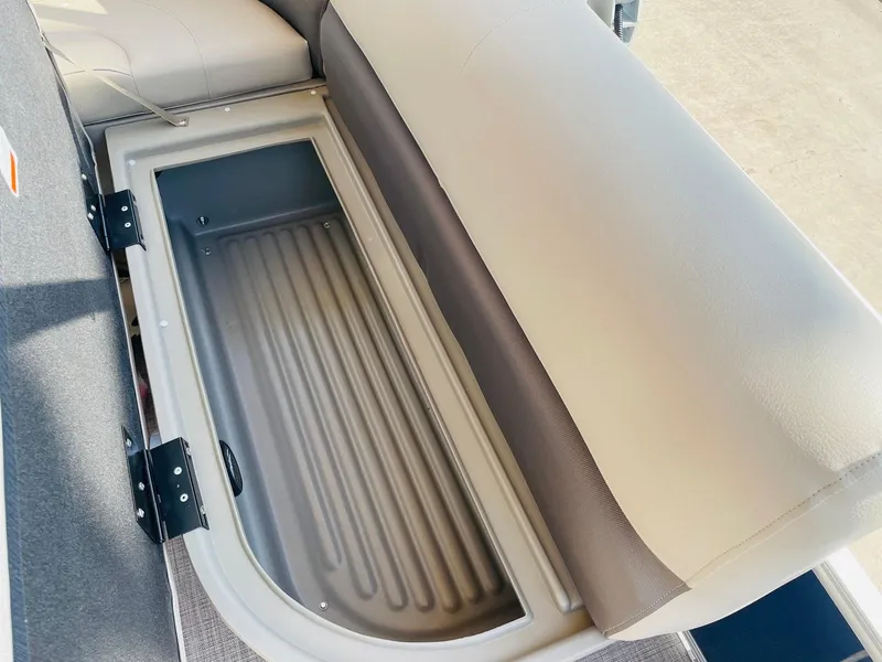 Slide: The Image of 2025 Sun Tracker Bass Buggy 18 DLX storage compartment with open seat. - 23