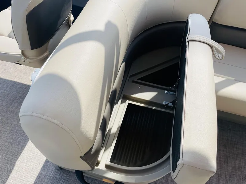 Slide: The Image of 2025 Sun Tracker Bass Buggy 18 DLX boat seat with storage compartment open. - 24