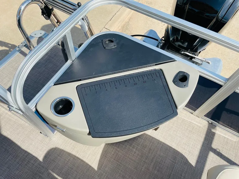 Slide: The Image of 2025 Sun Tracker Bass Buggy 18 DLX fishing station with cup holders and measuring board. - 26