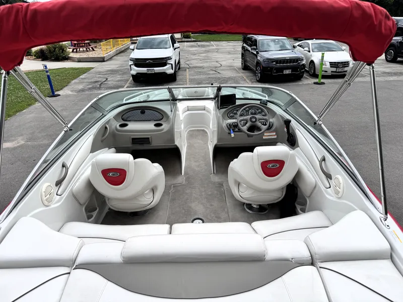Slide: The Image of 2004 Crownline 206 LS boat interior with red canopy and white seating. - 10
