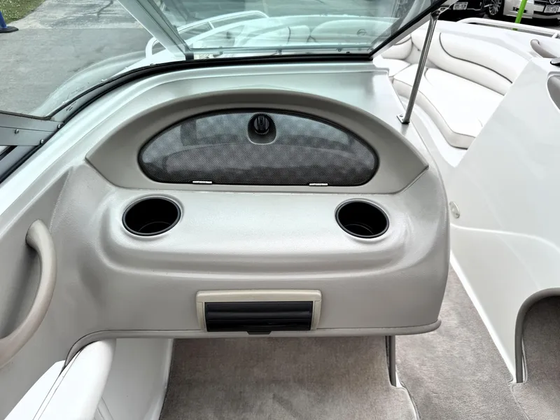 Slide: The Image of 2004 Crownline 206 LS boat interior with cup holders and storage compartment. - 18