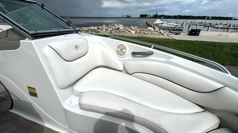 Slide: The Image of 2004 Crownline 206 LS boat interior with white seating, dockside view. - 21