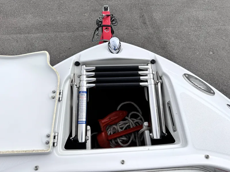 Slide: The Image of Open storage compartment on 2004 Crownline 206 LS boat, showing ladder and rope. - 22