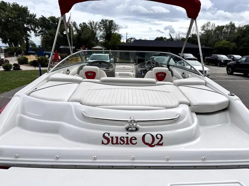 Slide: The Image of 2004 Crownline 206 LS boat with "Susie Q2" name, white interior, and red canopy. - 24
