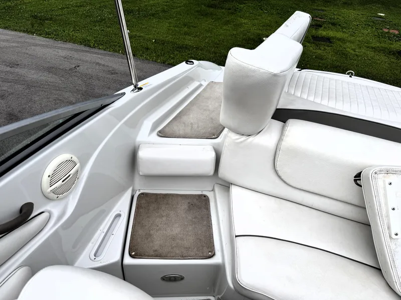 Slide: The Image of Interior of a 2004 Crownline 206 LS boat with white seating and carpeted flooring. - 8