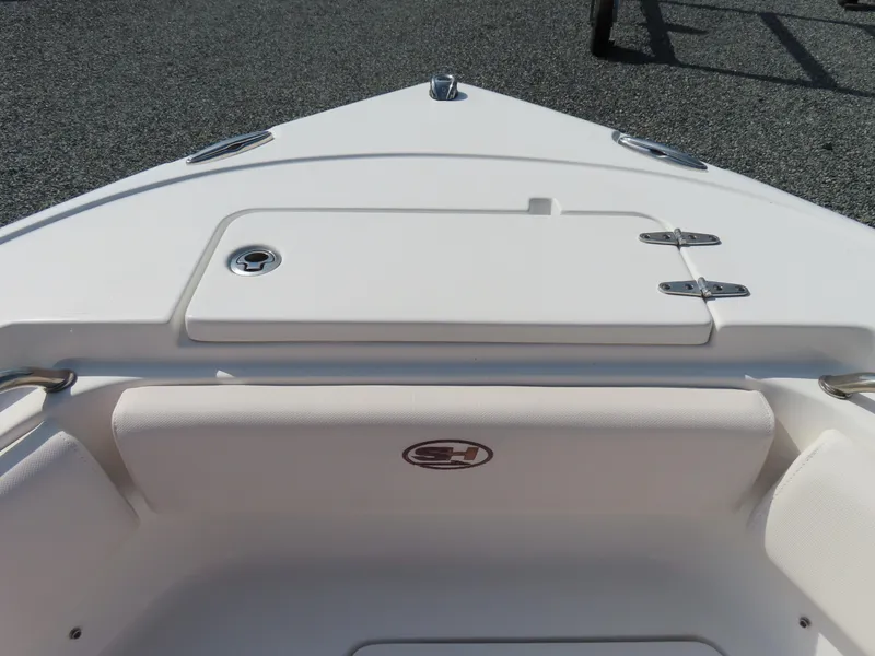 Slide: The Image of 2021 Sea Hunt Ultra 219 boat bow with storage compartment and seating. - 12