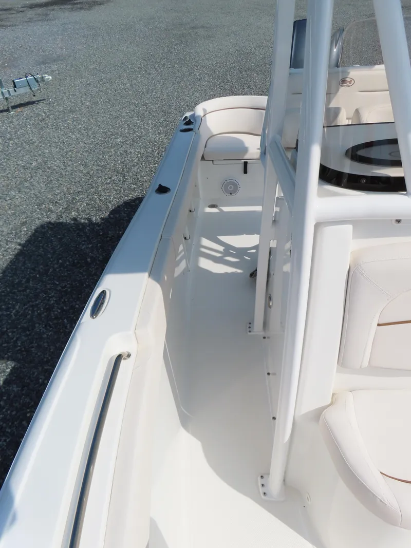 Slide: The Image of 2021 Sea Hunt Ultra 219 boat interior with seating and console. - 15