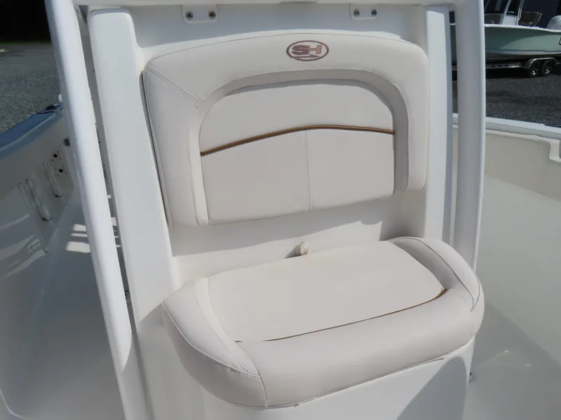 Slide: The Image of 2021 Sea Hunt Ultra 219 boat seat with white cushioned design. - 17