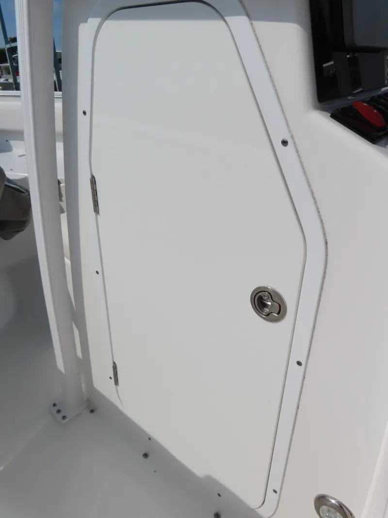 Slide: The Image of 2021 Sea Hunt Ultra 219 boat storage compartment with secure lock. - 19