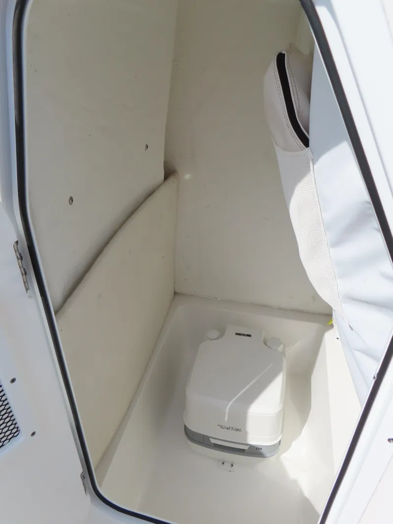 Slide: The Image of 2021 Sea Hunt Ultra 219 boat interior with portable toilet. - 20