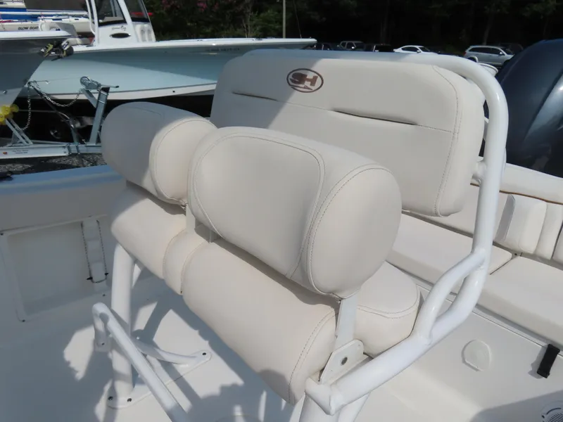 Slide: The Image of 2021 Sea Hunt Ultra 219 boat seat with white cushioned backrest and armrests. - 22