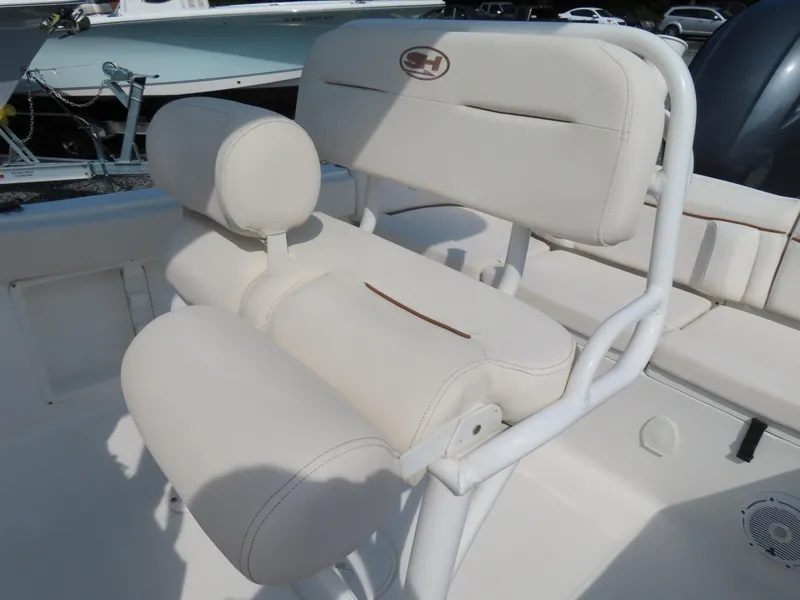 Slide: The Image of 2021 Sea Hunt Ultra 219 boat seating with white upholstery and logo. - 23