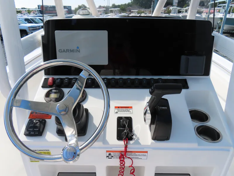 Slide: The Image of 2021 Sea Hunt Ultra 219 boat dashboard with Garmin display and Yamaha controls. - 24