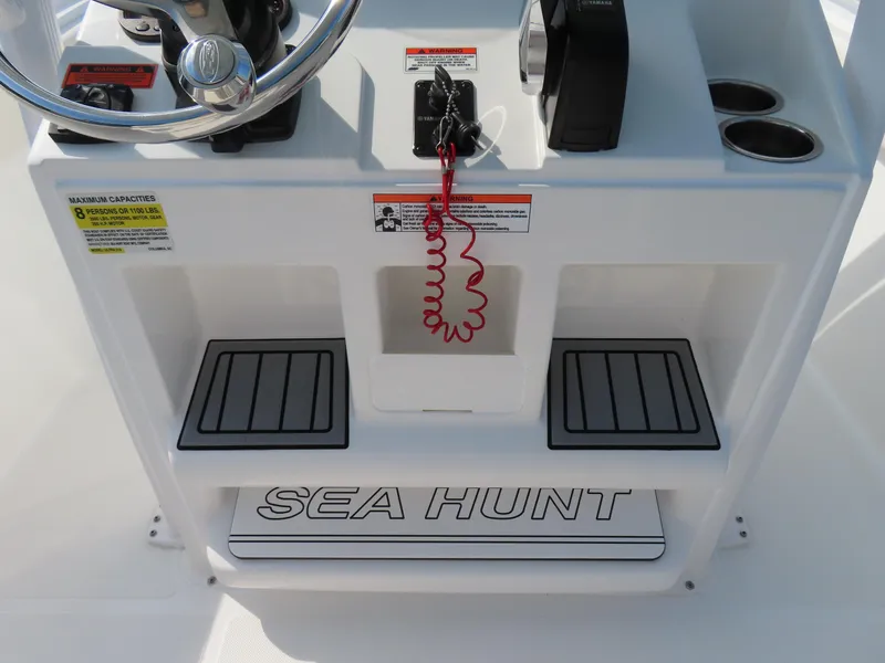 Slide: The Image of 2021 Sea Hunt Ultra 219 boat console with steering wheel and safety features. - 26