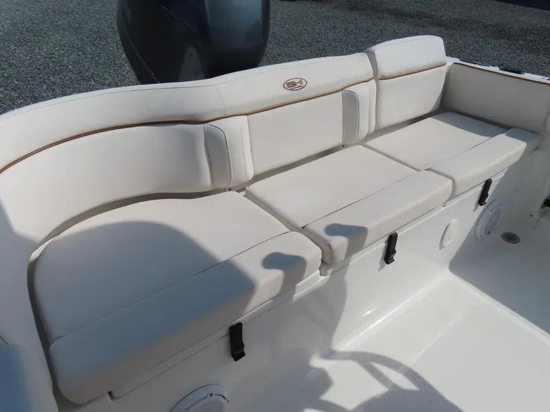 Slide: The Image of 2021 Sea Hunt Ultra 219 boat with cushioned seating and sleek design. - 30