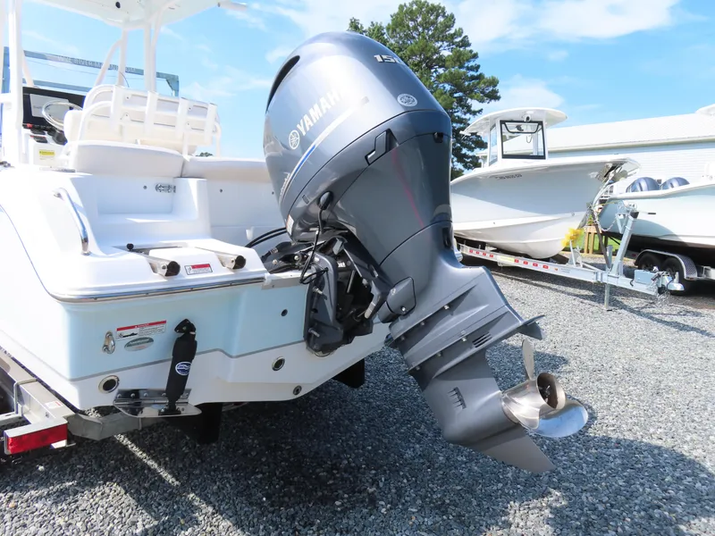 Slide: The Image of 2021 Sea Hunt Ultra 219 boat with Yamaha outboard motor on gravel lot. - 5
