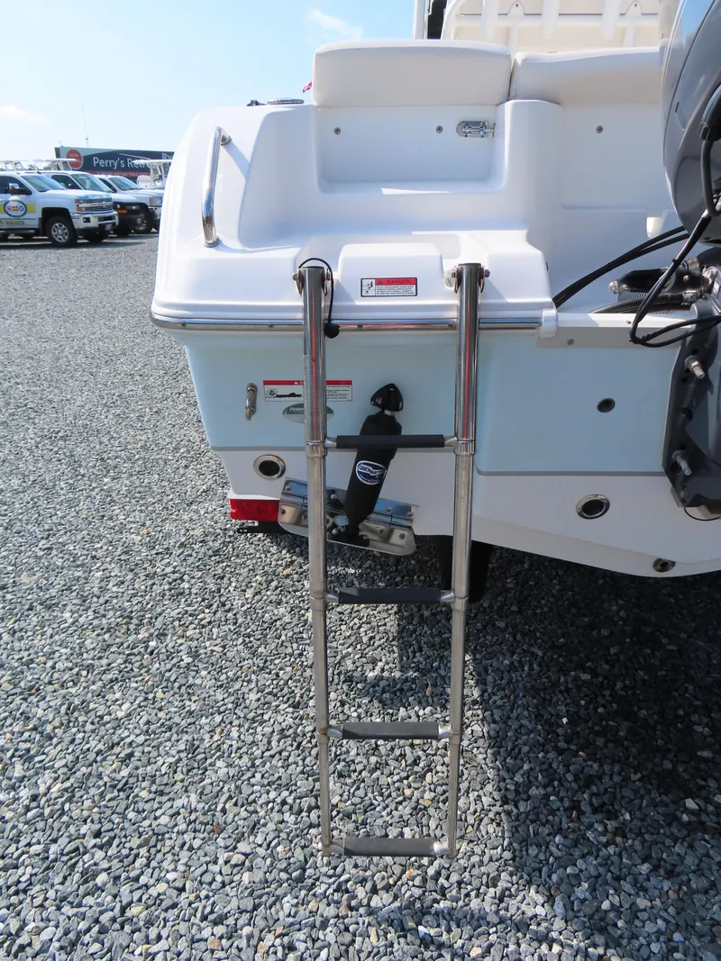 Slide: The Image of Rear view of 2021 Sea Hunt Ultra 219 boat with ladder on gravel surface. - 6