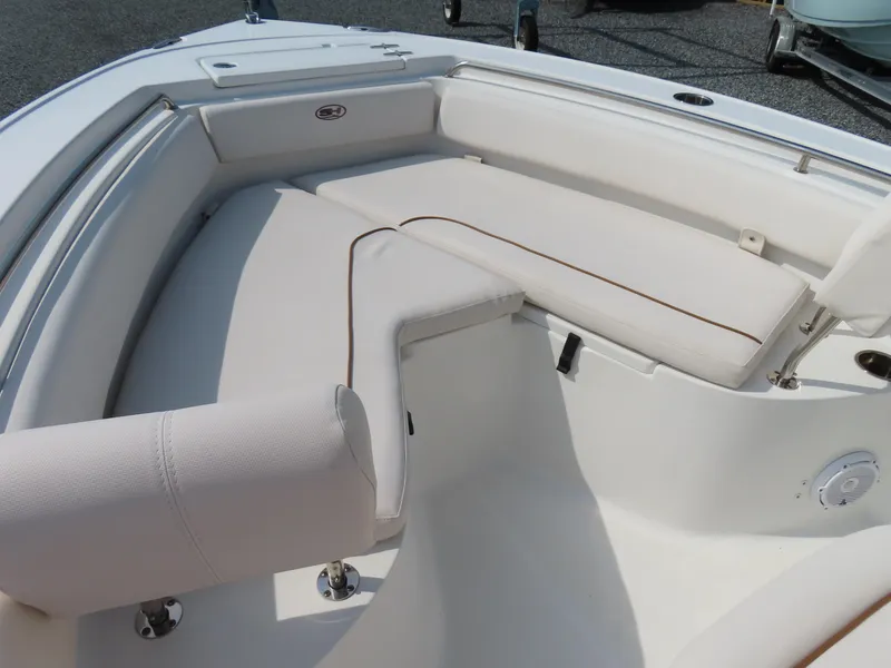 Slide: The Image of 2021 Sea Hunt Ultra 219 boat interior with white cushioned seating. - 7