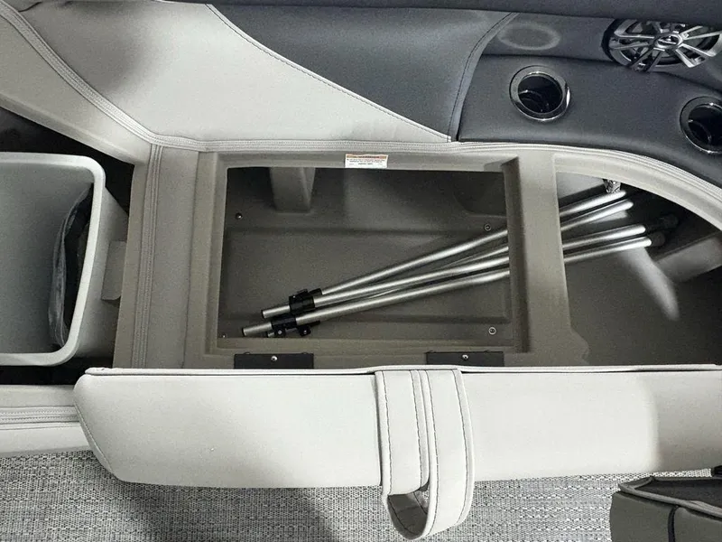 Slide: The Image of 2025 Barletta A20QC boat interior storage compartment with metal poles and cup holders. - 11