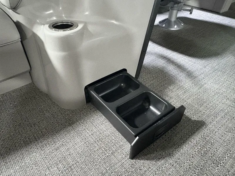 Slide: The Image of 2025 Barletta A20QC boat interior with pull-out storage drawer and cup holder. - 12