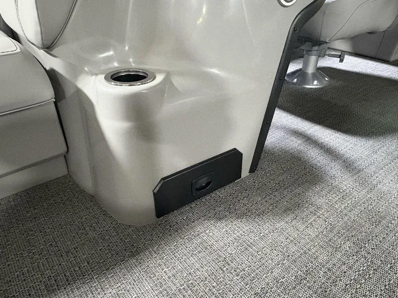 Slide: The Image of Interior of 2025 Barletta A20QC boat, featuring cup holder and carpeted flooring. - 14