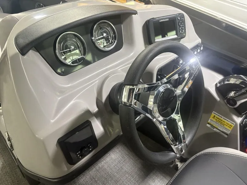 Slide: The Image of 2025 Barletta A20QC boat dashboard with steering wheel and gauges. - 15