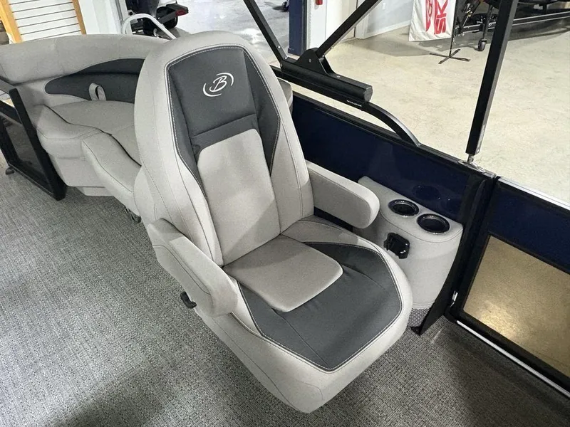 Slide: The Image of 2025 Barletta A20QC boat interior with plush seating and cup holders. - 19