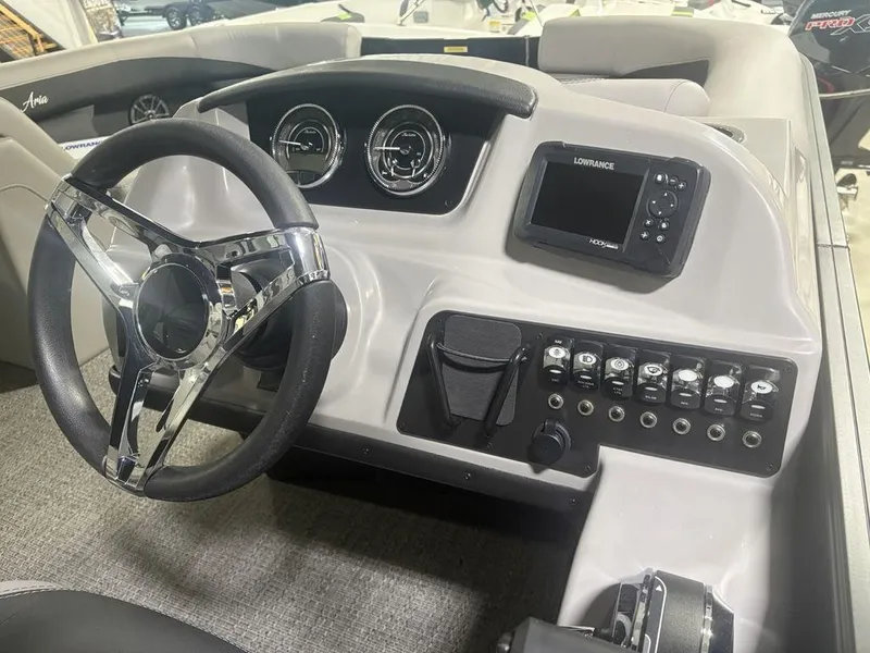 Slide: The Image of 2025 Barletta A20QC boat dashboard with steering wheel and control panel. - 22