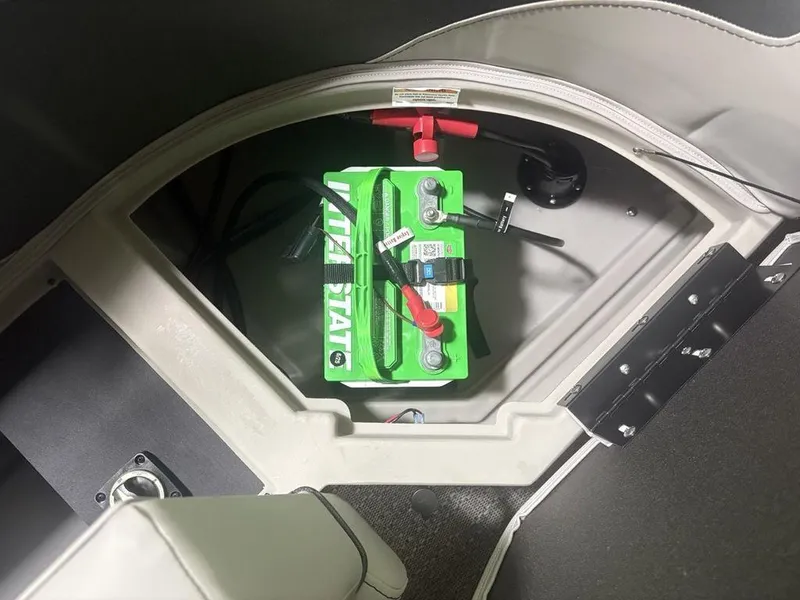 Slide: The Image of Battery compartment of 2025 Barletta A20QC boat, featuring a green battery. - 27