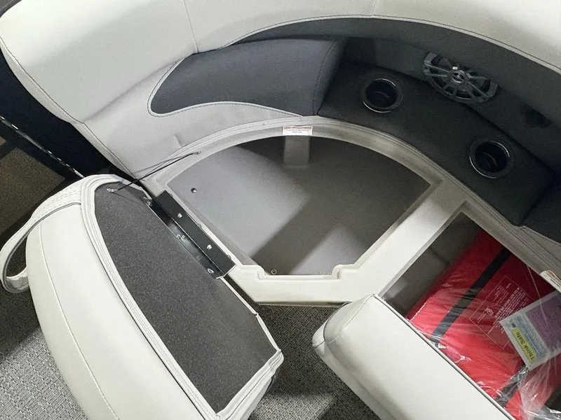 Slide: The Image of 2025 Barletta A20QC boat interior storage compartment with seating and cup holders. - 4