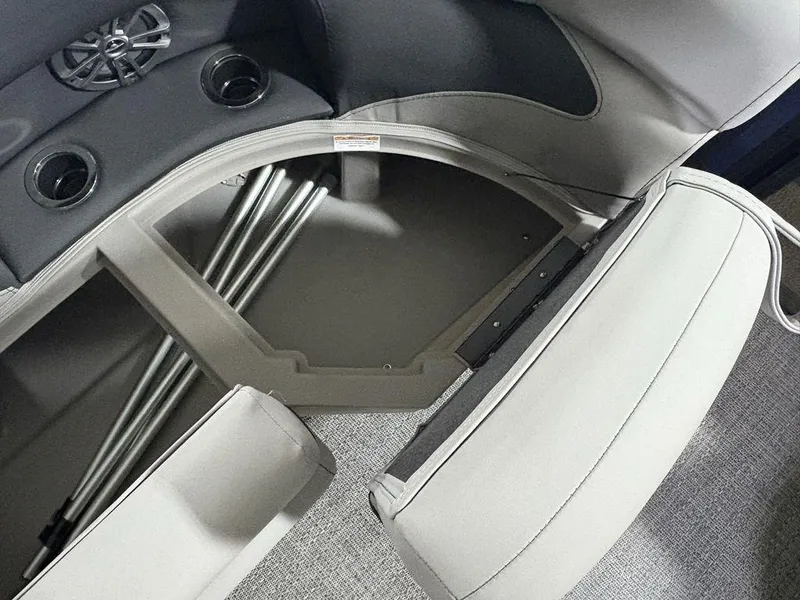 Slide: The Image of 2025 Barletta A20QC boat interior storage compartment with cup holders and speaker. - 7