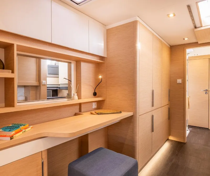 Slide: The Image of Luxurious interior of 2025 Fountaine Pajot NEW 41 yacht with modern wood finish and workspace. - 17