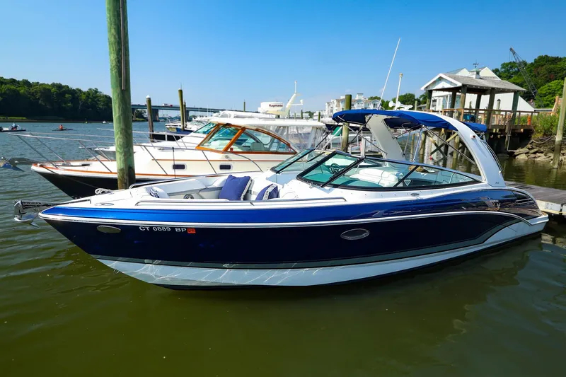 The Image of 2013 Formula 290 Bowrider boat docked in a marina on a sunny day. - 1